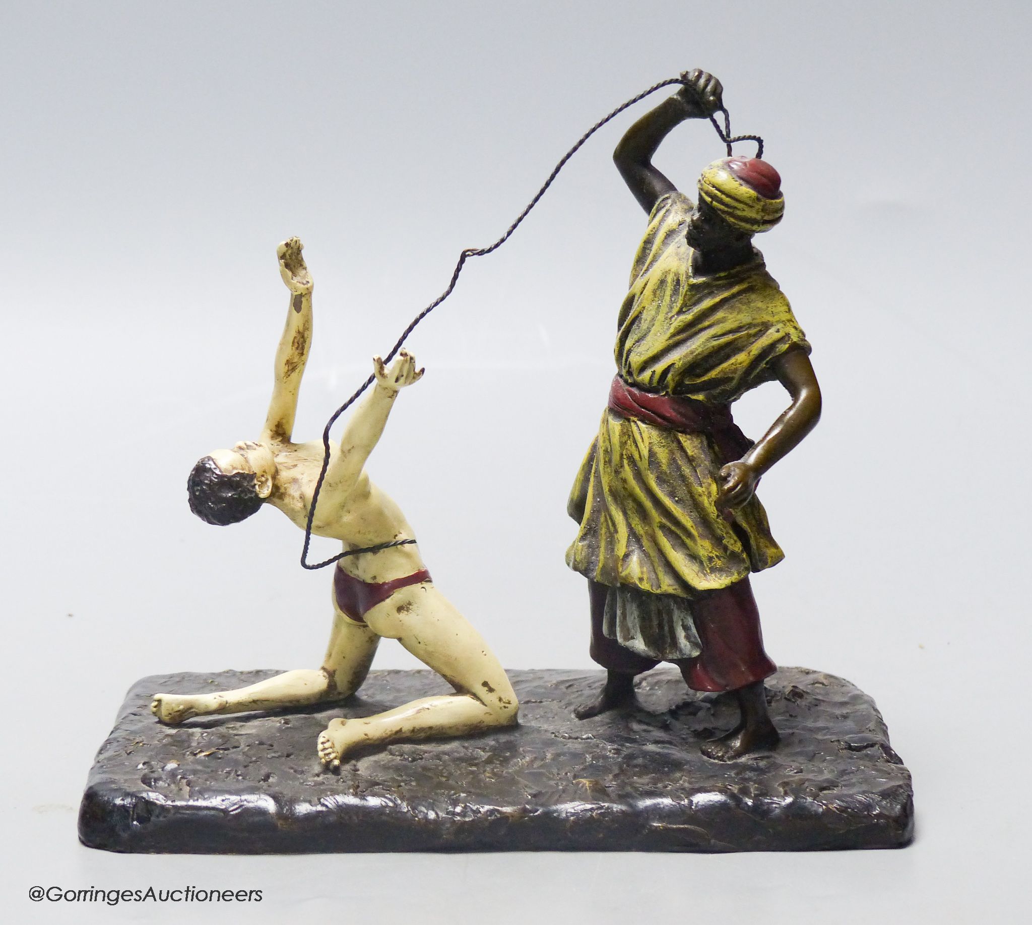 Attributed to Franz Bergmann, a cold painted bronze model of a slave trader, whipping a nude slave, stamped with shield and 'Nan Creb'